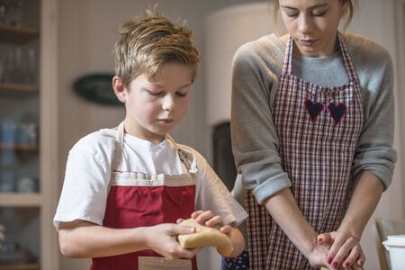 Kids baking gingerbread at home for christmas.の写真素材