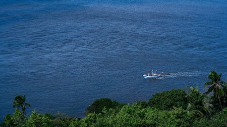 Fishermen boat safely navigating through sea after the devastating Cyclone 'Nisarg'の写真素材