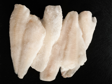 Frozen fish on a stone plateの写真素材