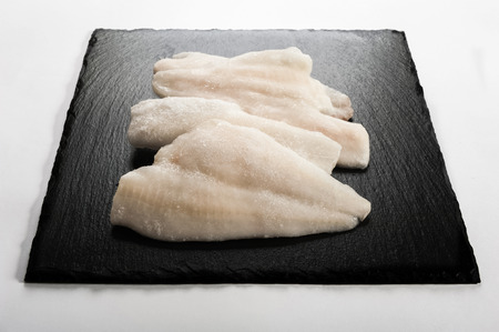 Frozen fish on a stone plateの写真素材
