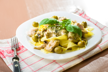 Tagliatelle pasta with chicken and mushrooms in cream sauceの写真素材