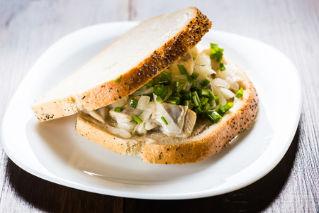 sandwich with herring with onions and chivesの写真素材