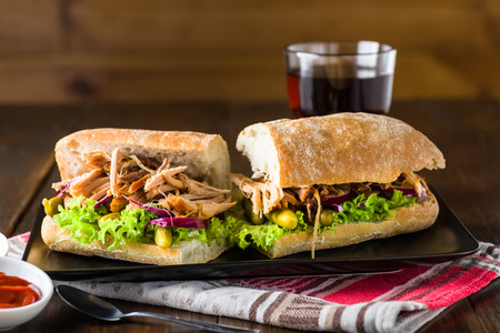 pulled pork sandwich on black plateの写真素材