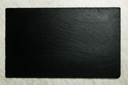 Rectangular stone plate - top view on marble backgroundの写真素材