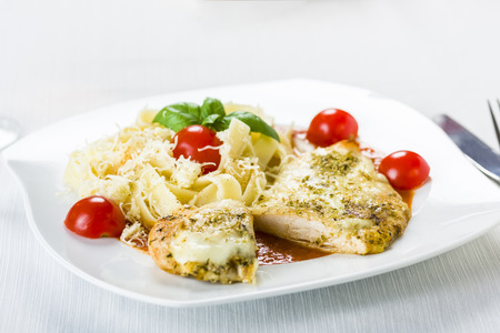 Chicken fillet in tomato sauce with olives and grated mozzarellaの写真素材