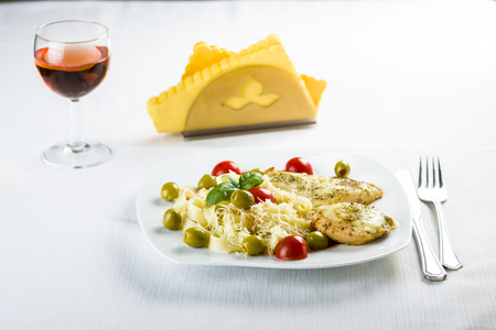 Chicken fillet in tomato sauce with olives and grated mozzarellaの写真素材