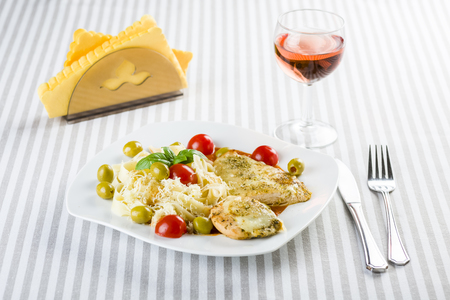 Chicken fillet in tomato sauce with olives and grated mozzarellaの写真素材