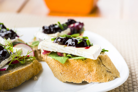 Cheeks before main meal - small sandwiches with arugula and cheeseの写真素材