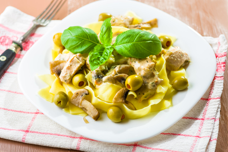 Tagliatelle pasta with chicken and mushrooms in cream sauceの写真素材
