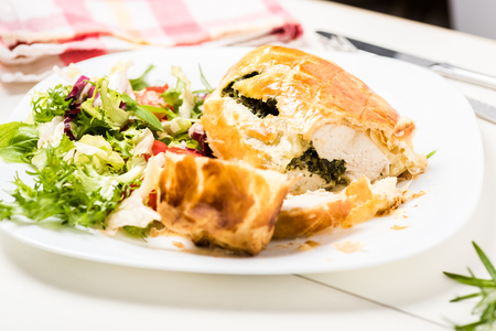 chicken breast stuffed spinach in puff pastry with lettuce mixの写真素材