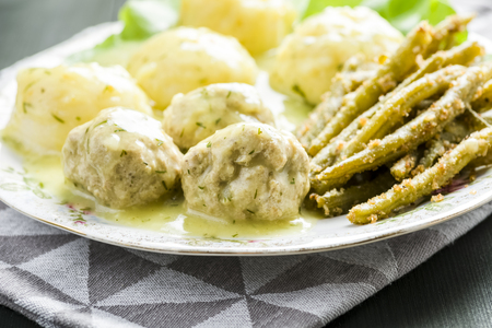 Meatballs in dill sauce with potatoes and green beansの写真素材