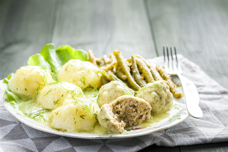 Meatballs in dill sauce with potatoes and green beansの写真素材