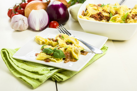 Tortellini dumplings with ham and basilの写真素材