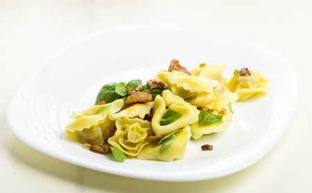 Tortellini dumplings with ham and basilの写真素材