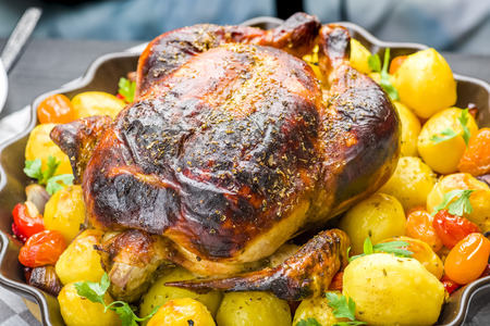 roast chicken with potatoes and other vegetablesの写真素材