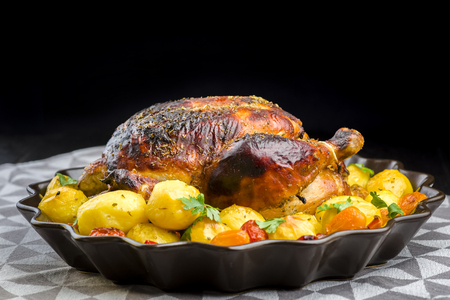 roast chicken with potatoes and other vegetablesの写真素材