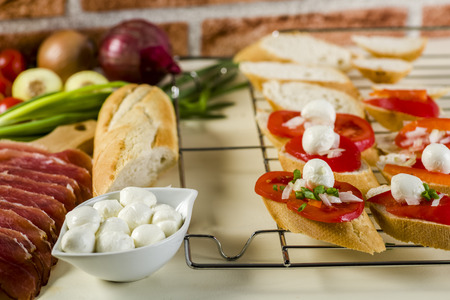 bruschetta with tomatoes, mozzarella, Parma ham and basil - seasoned with oreganoの写真素材