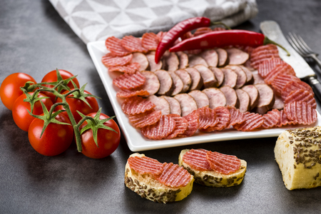 smoked sausage and spicy salami - a photo in a rustic styleの写真素材