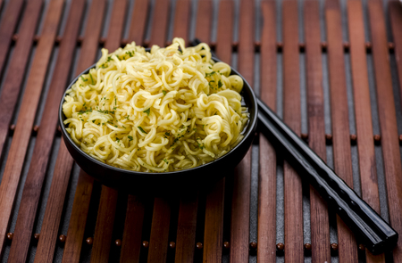 flavors of Asia - Chinese noodles in a bowl with broth and chopsticksの写真素材