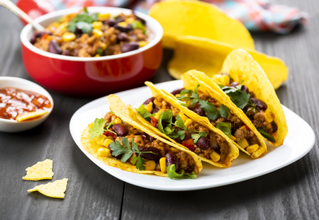 Mexican food - delicious tacos with minced meat, beans and cornの写真素材