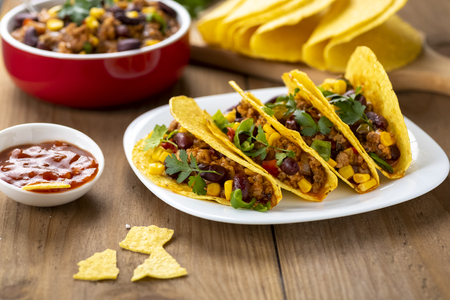 Mexican food - delicious tacos with minced meat, beans and cornの写真素材