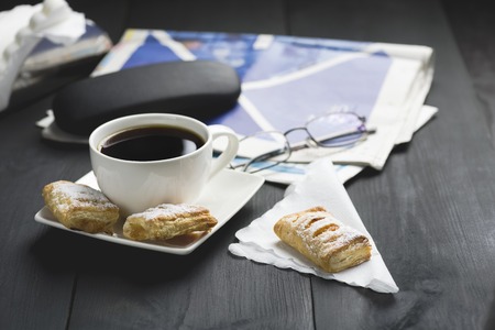 a cup of coffee and something sweet to the morning newspaper - nice start to the day