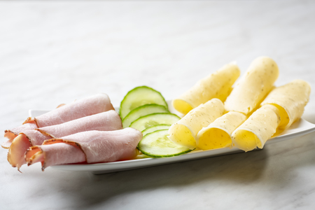 a plate of snacks - ham, cheese, cucumberの写真素材