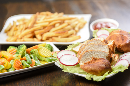 roasted chicken fillet served with vegetablesの写真素材