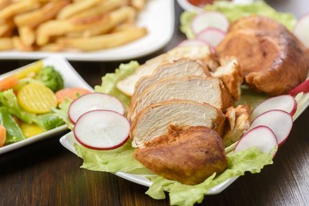 roasted chicken fillet served with vegetablesの写真素材