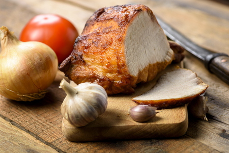 roasted pork loin with spices - garlic, onion, tomato, basilの写真素材