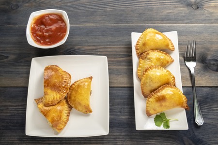 Empanada - a dish of South American cuisine - baked dumplings stuffed with meat and vegetableの写真素材