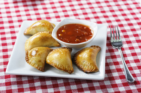 Empanada - a dish of South American cuisine - baked dumplings stuffed with meat and vegetableの写真素材
