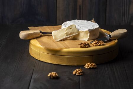 camembert cheese with nuts, cranberries and cherry tomatoesの写真素材