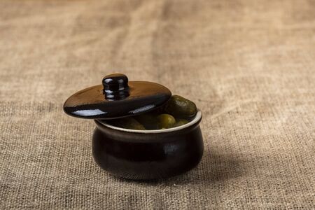 pickled cucumbers in a stone potの写真素材