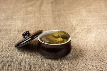 pickled cucumbers in a stone potの写真素材