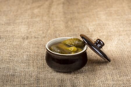 pickled cucumbers in a stone potの写真素材