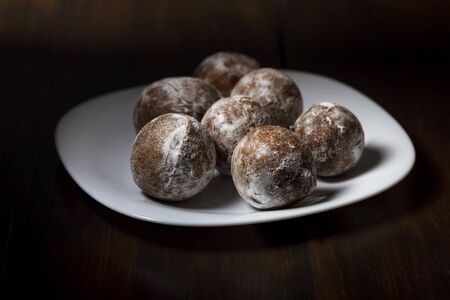 mini cheese donuts on a white plate - dark food style photoの写真素材