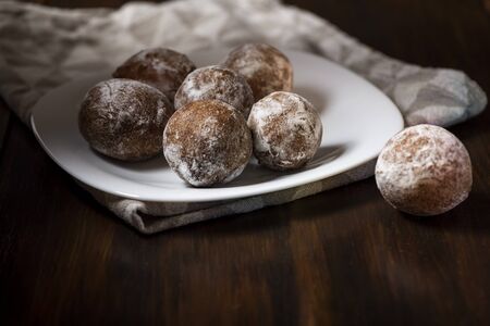 mini cheese donuts on a white plate - dark food style photoの写真素材