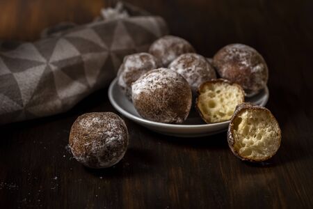 mini cheese donuts on a white plate - dark food style photoの写真素材