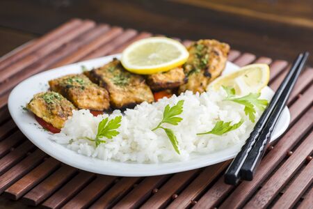 Fish in herbs seasoned with rice. Served on vegetablesの写真素材