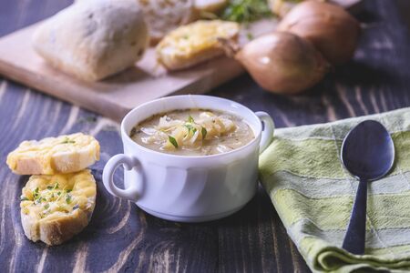 Onion soup served with cheese croutonsの写真素材