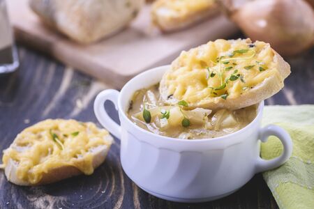 Onion soup served with cheese croutonsの写真素材