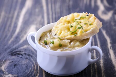 Onion soup served with cheese croutonsの写真素材