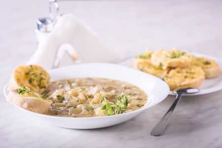 Onion soup served with cheese croutonsの写真素材