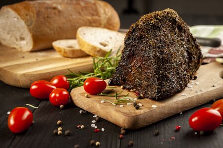 roast beef sandwich surrounded by herbs and vegetablesの写真素材