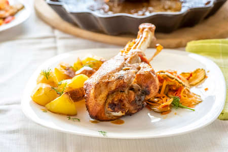 baked turkey leg with potatoes and vegetable saladの写真素材