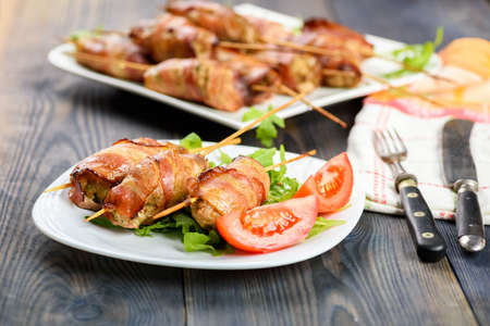 Kofta kebab - skewers of minced meat surrounded by slices of baconの写真素材