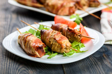 Kofta kebab - skewers of minced meat surrounded by slices of baconの写真素材
