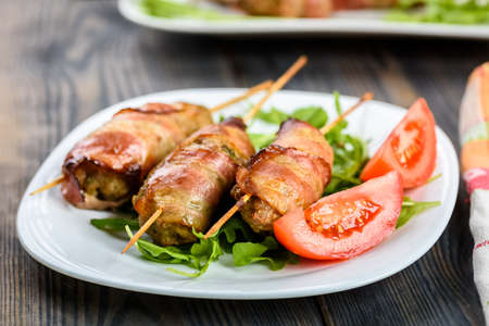 Kofta kebab - skewers of minced meat surrounded by slices of baconの写真素材