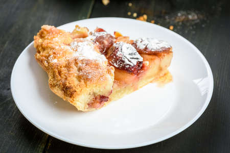 homemade apple and plum cake on wooden tableの写真素材